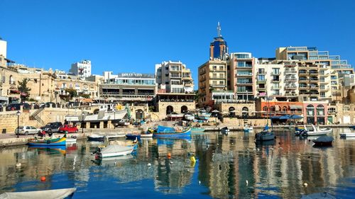 Boats moored at harbor