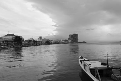 Scenic view of sea by buildings against sky