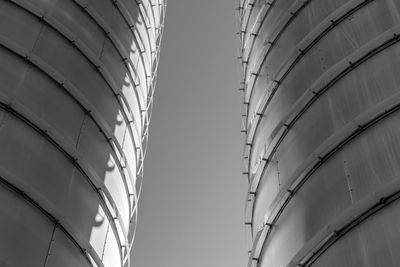 Low angle view of tanks against sky