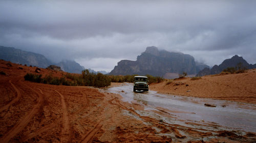 Cars on mountain road during rainy season