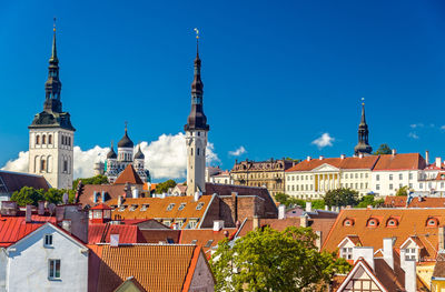 Buildings in city against blue sky