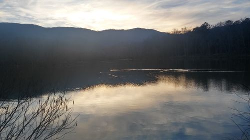 Scenic view of lake against sky during sunset