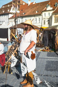 Man standing by street market in city