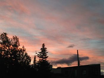 Low angle view of silhouette trees against sky at sunset