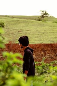 Rear view of man standing on field