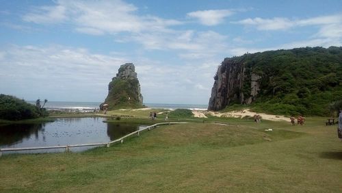 View of beach against cloudy sky