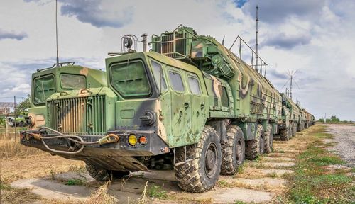 Low angle view of abandoned truck on field against sky