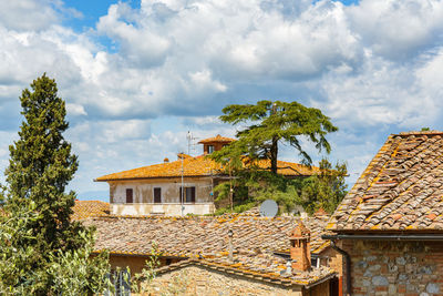 Trees and old building against sky