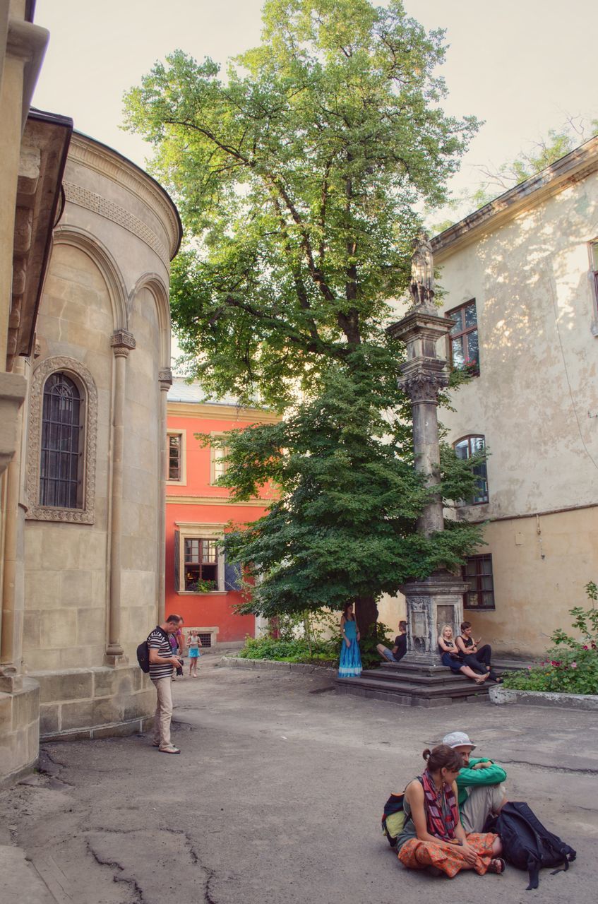 PEOPLE ON STREET BY BUILDING