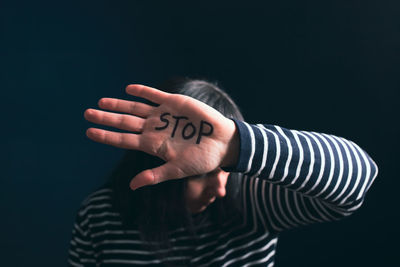 Close-up of human hand against black background