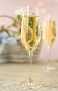 Close up of wineglass on table. background spring flowers. champagne glass. 