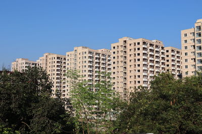 Low angle view of buildings against blue sky