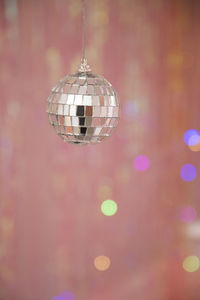 Close-up of illuminated lanterns hanging on street light at night