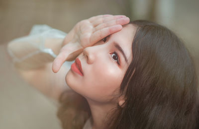 Close-up of young woman looking up