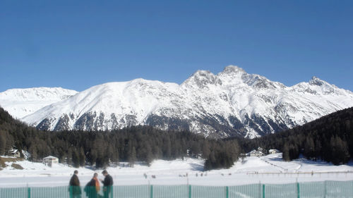 Scenic view of snow covered mountains against clear sky