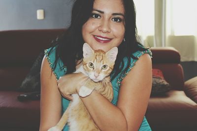 Portrait of smiling woman sitting at home