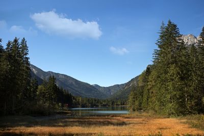 Scenic view of lake and mountains against sky