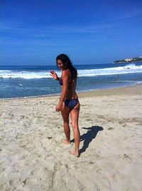 Full length of woman on beach against sea