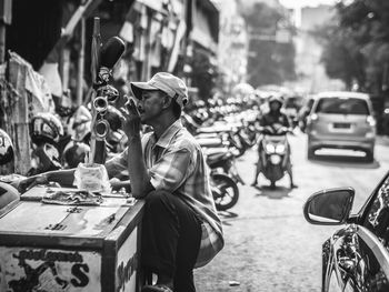 Man with umbrella on street in city