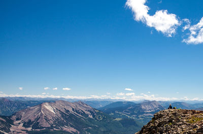 Scenic view of mountains against blue sky