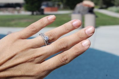 Cropped hand wearing diamond ring