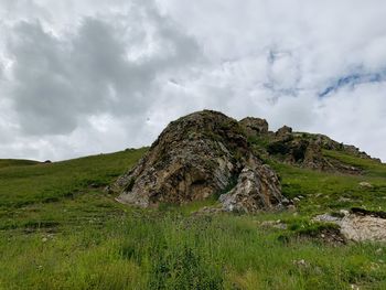 Scenic view of rocks on field against sky