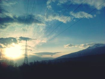 Scenic view of silhouette mountains against sky at sunset