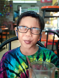 Portrait of boy with drink in restaurant