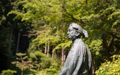 Statue against trees