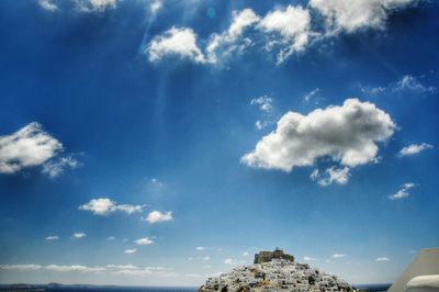 Buildings on cliff against sky at astypalaia