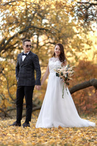 Portrait of smiling couple standing in park