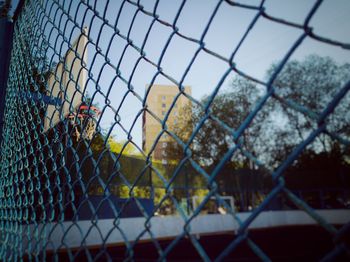 Close-up of chainlink fence against the sky