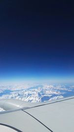 Aerial view of airplane wing against sky