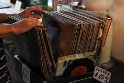 Close-up of hands choosing record