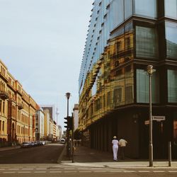 Rear view of woman walking on street in city