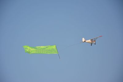 Low angle view of airplane against clear sky