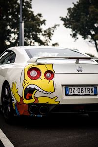 Yellow toy car on road in city