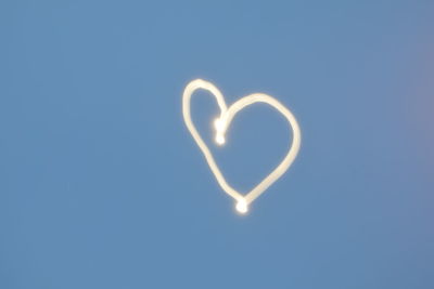 Low angle view of heart shape moon against clear sky