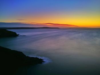 Scenic view of sea against clear sky during sunset