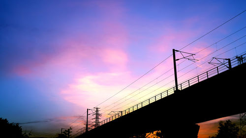 Low angle view of silhouette bridge against sky during sunset