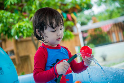 Cute boy  holding hose