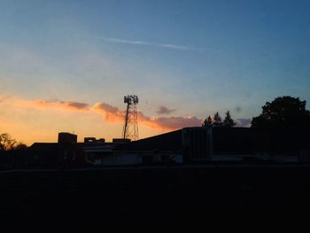 Silhouette built structures at sunset