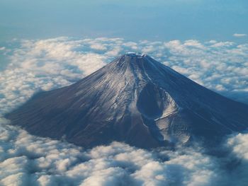 Idyllic shot of mountain amidst clouds