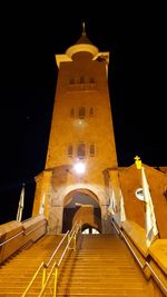 Low angle view of illuminated building against sky at night