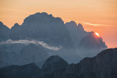 Panoramic view of mountain range against sky during sunset