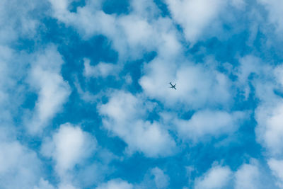 Low angle view of airplane flying in sky