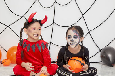 Portrait of smiling girl in traditional clothing during halloween