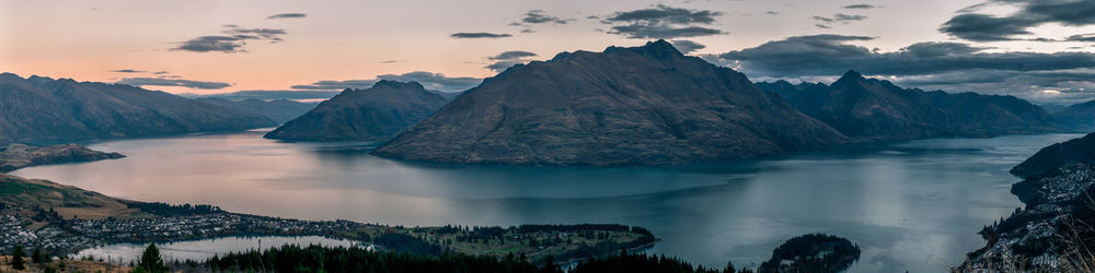 Panoramic view of sea and mountains against sky during sunset