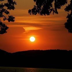 Scenic view of silhouette landscape against romantic sky at sunset