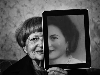 Portrait of mature woman holding digital tablet